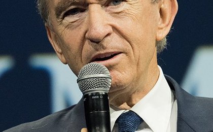 Who is Bernard Arnault, the owner of Louis Vuitton, and how much does he earn?