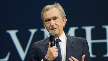 Who is Bernard Arnault, the owner of Louis Vuitton, and how much does he earn?