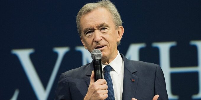 Who is Bernard Arnault, the owner of Louis Vuitton, and how much does he earn?
